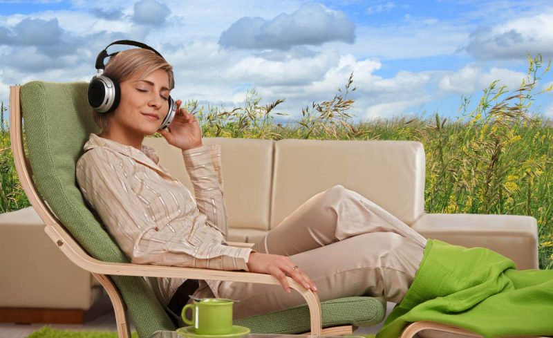 Woman with headphones, dreaming of being outdoors